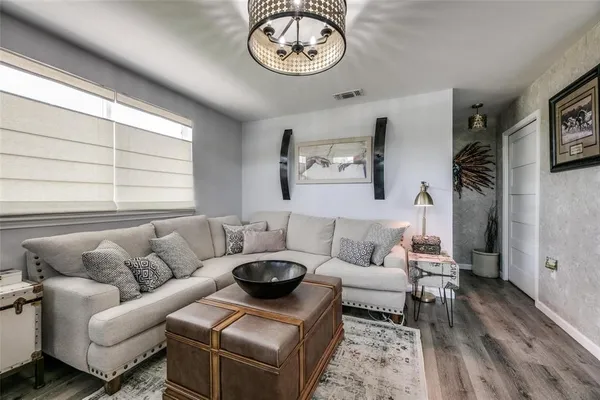 a living room with furniture a couch and a window