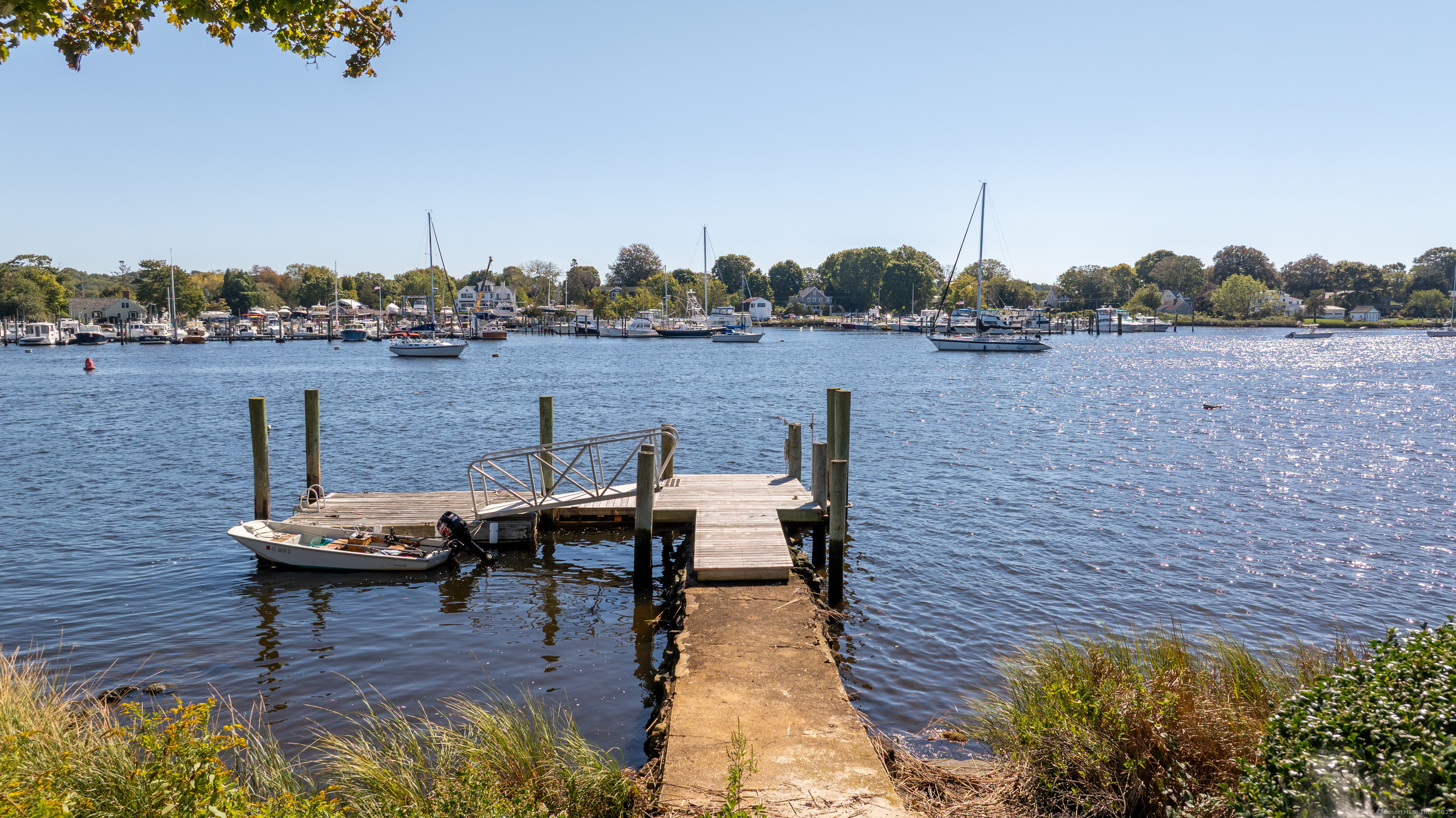 a view of a lake with couches chairs and a table