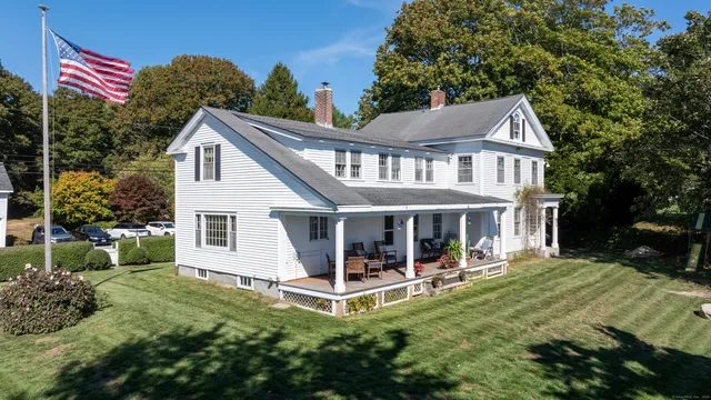 a view of a house with a yard deck and furniture