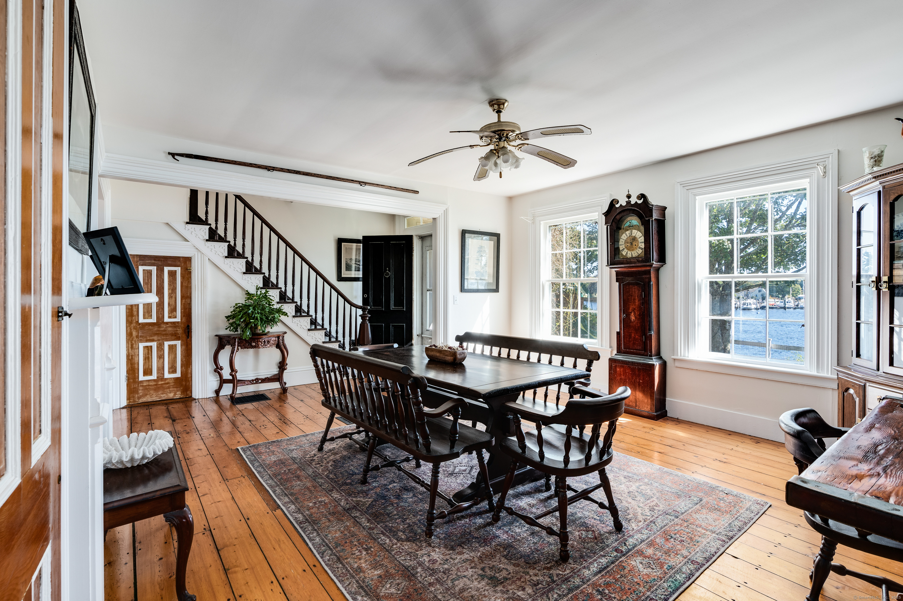 417 River Road Stonington, CT 06379 - Photo 16 of 39 a view of a dining room with furniture window and wooden floor