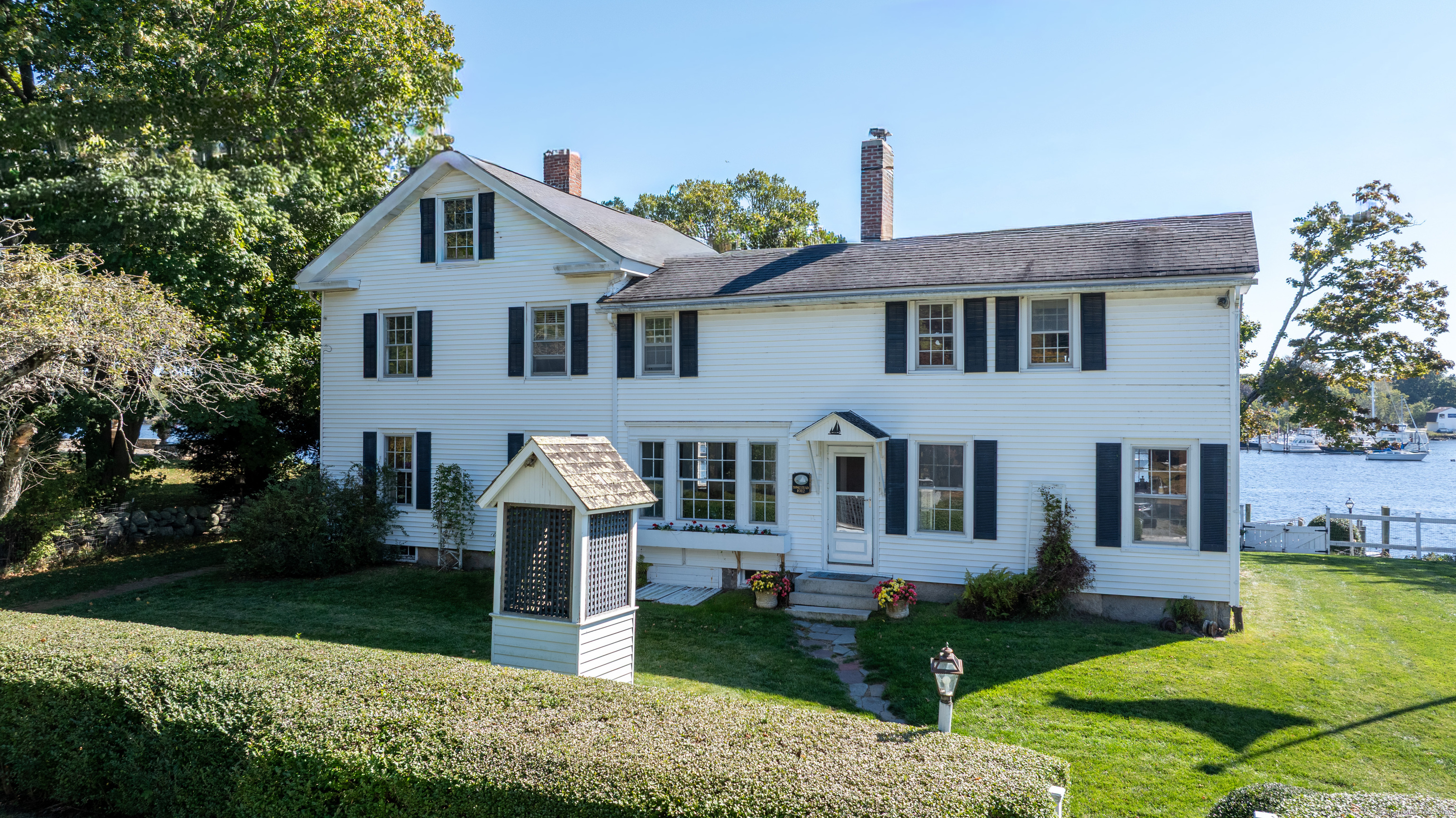 417 River Road Stonington, CT 06379 - Photo 2 of 39 a front view of a house with garden