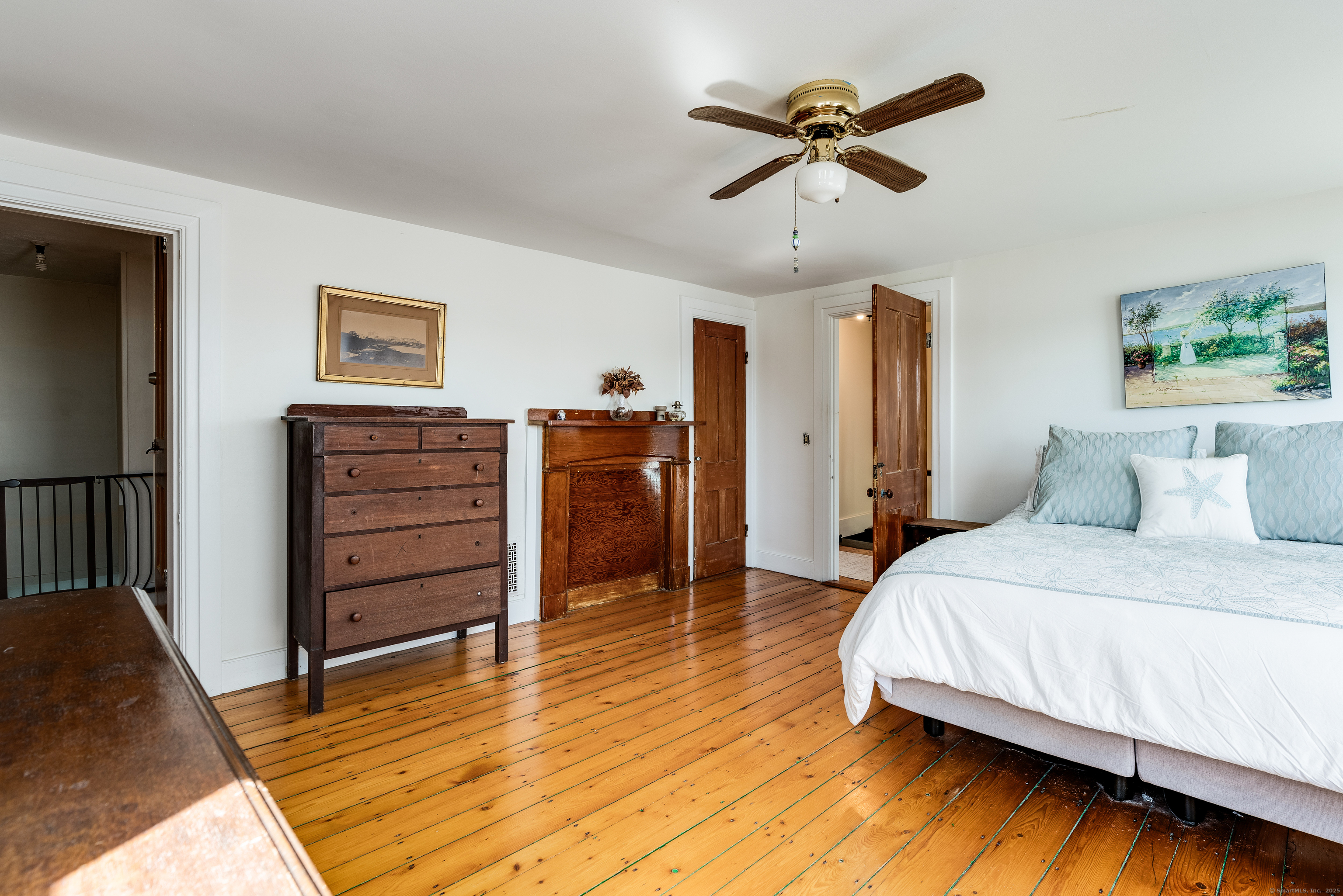417 River Road Stonington, CT 06379 - Photo 23 of 39 a spacious bedroom with a bed and a ceiling fan