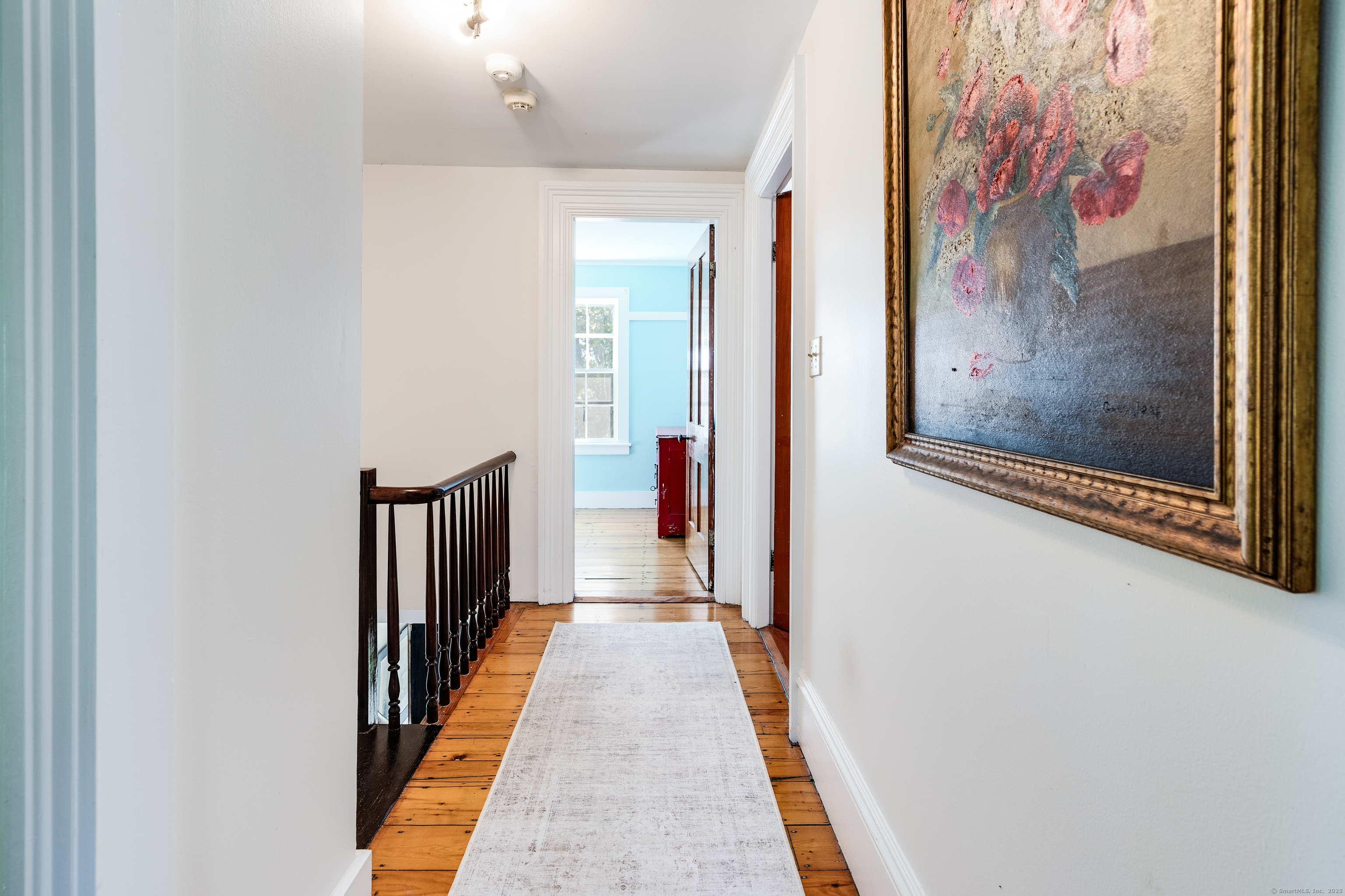 417 River Road Stonington, CT 06379 - Photo 25 of 39 a view of a hallway with wooden floor and stairs