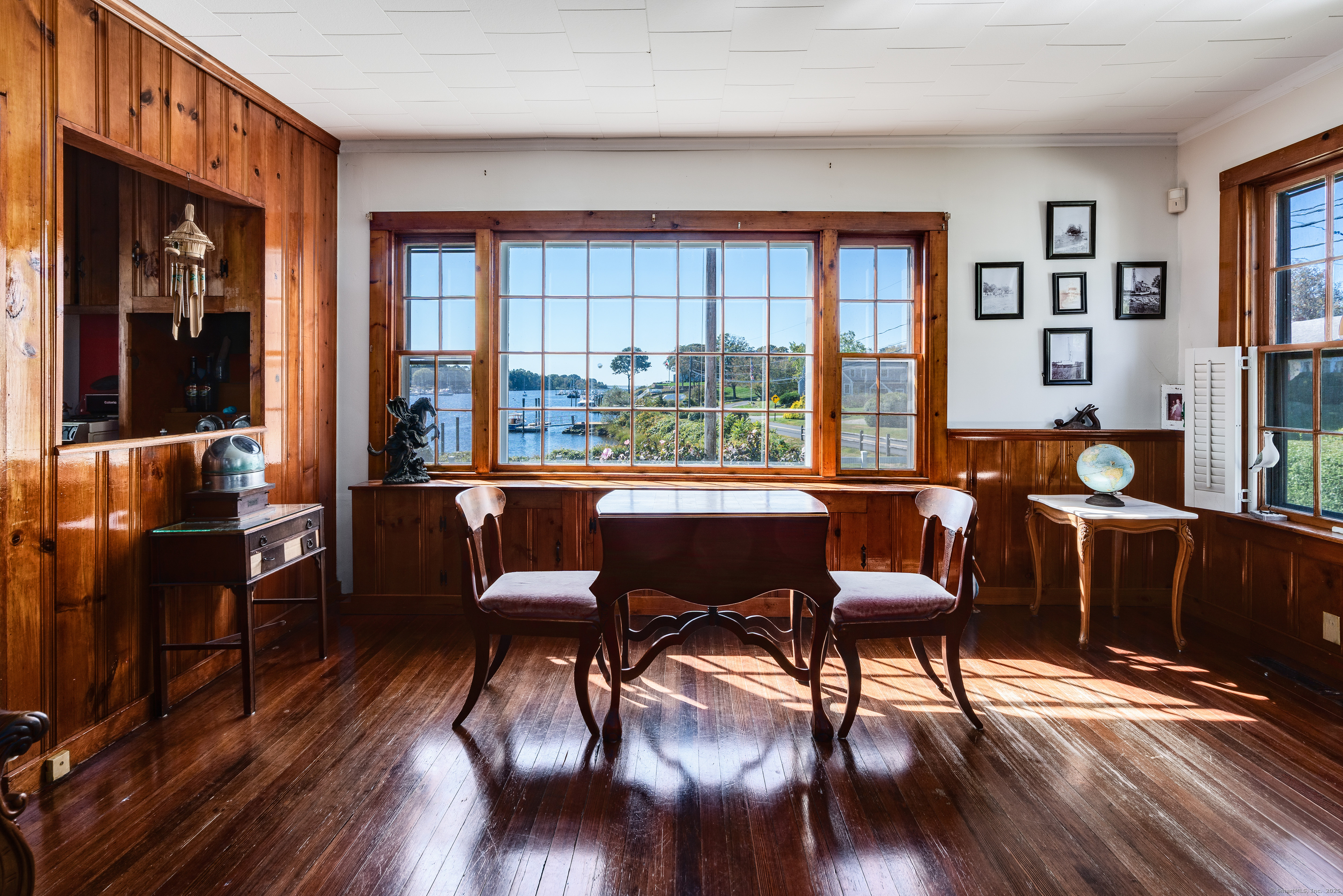 417 River Road Stonington, CT 06379 - Photo 3 of 39 a view of a dining room with furniture window and wooden floor
