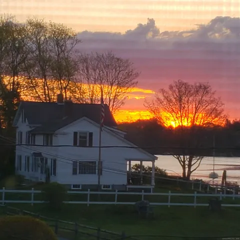 a roof deck view with a table and chairs