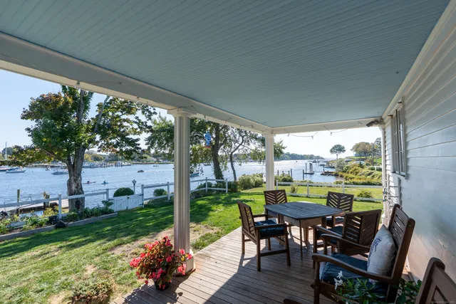 a view of a porch with furniture and garden