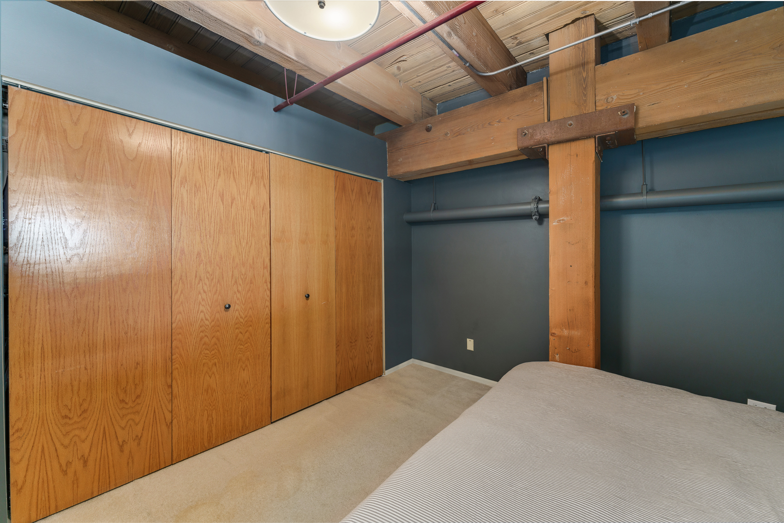 1733 West Irving Park Road, Unit 306 Chicago, IL 60613 - Photo 13 of 15 a bedroom with a bed and a chandelier