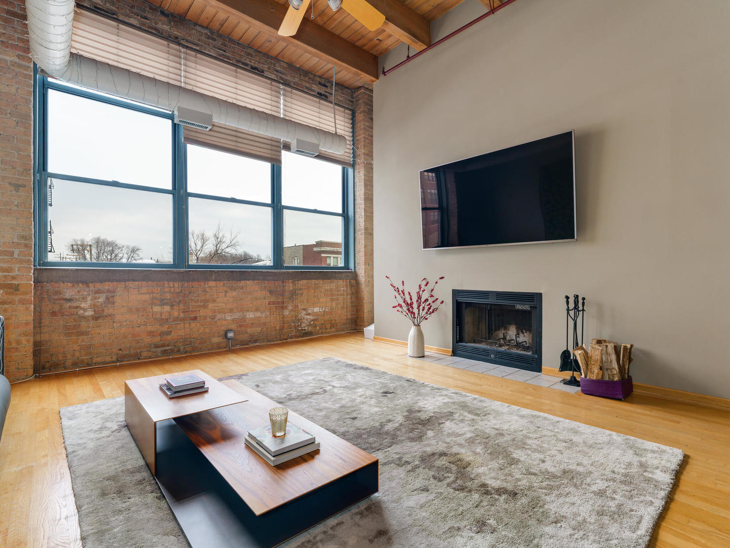 1733 West Irving Park Road, Unit 306 Chicago, IL 60613 - Photo 4 of 15 a living room with furniture and a fireplace