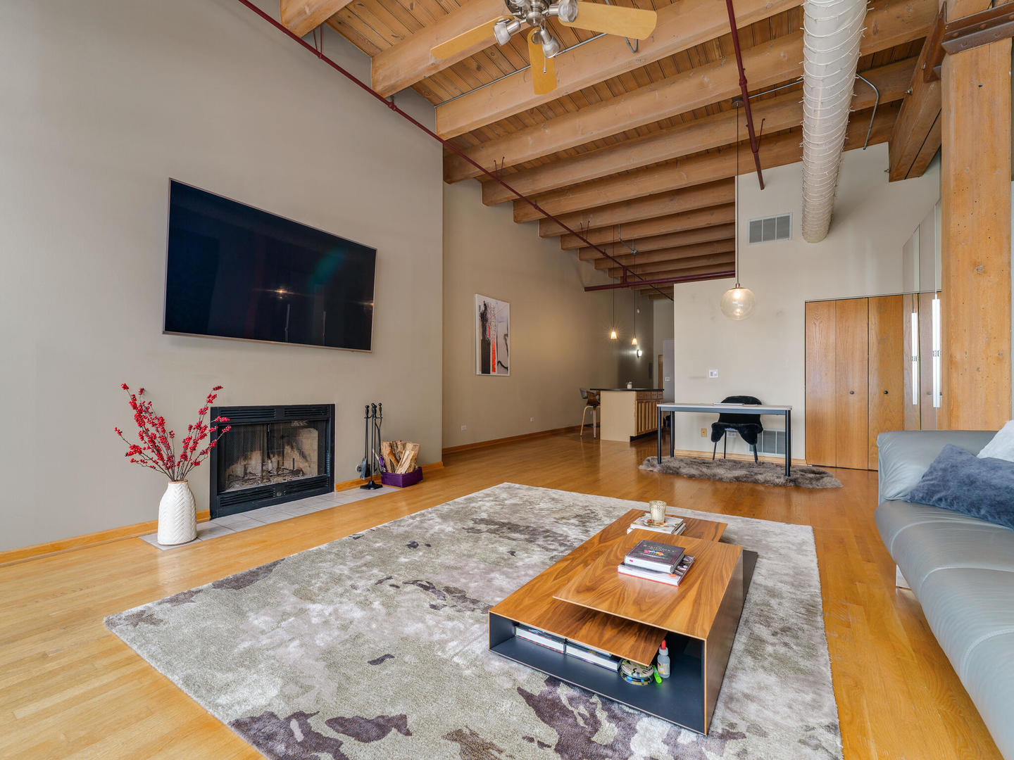 1733 West Irving Park Road, Unit 306 Chicago, IL 60613 - Photo 5 of 15 a living room with furniture and a fireplace