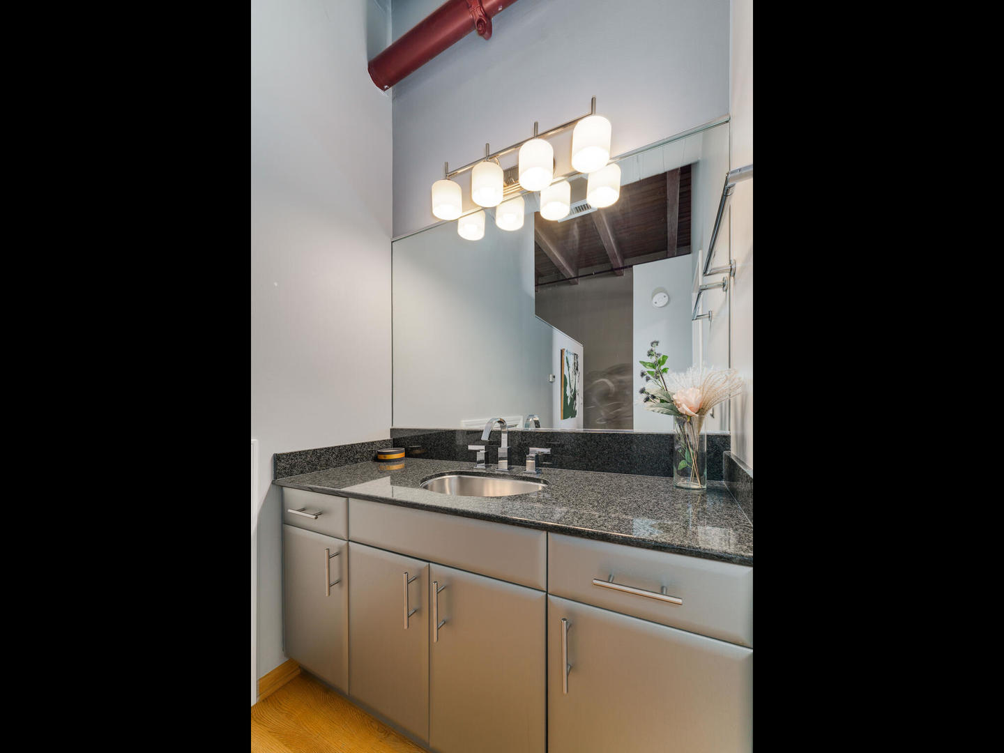 1733 West Irving Park Road, Unit 306 Chicago, IL 60613 - Photo 10 of 15 a bathroom with a sink and a mirror