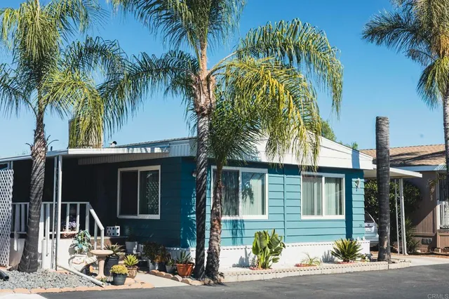 a front view of a house with a tree