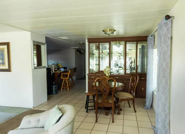 a view of a dining room with furniture and a chandelier