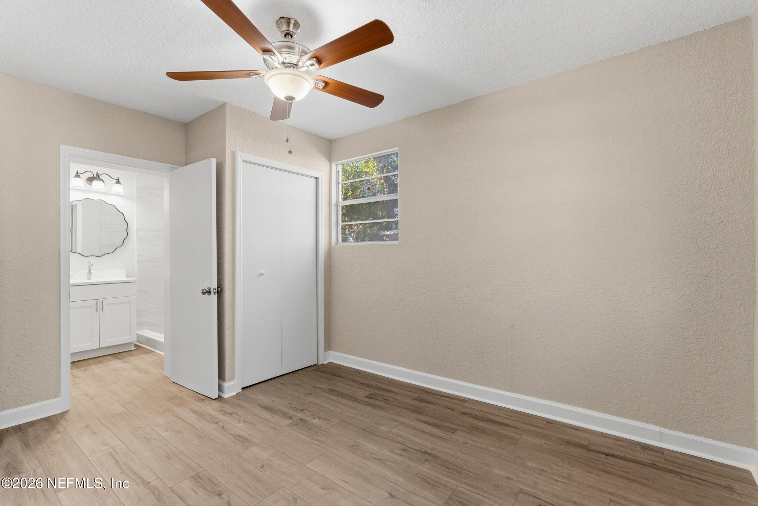10531 Rutgers Road Jacksonville, FL 32218 - Photo 17 of 32 an empty room with wooden floor and a ceiling fan