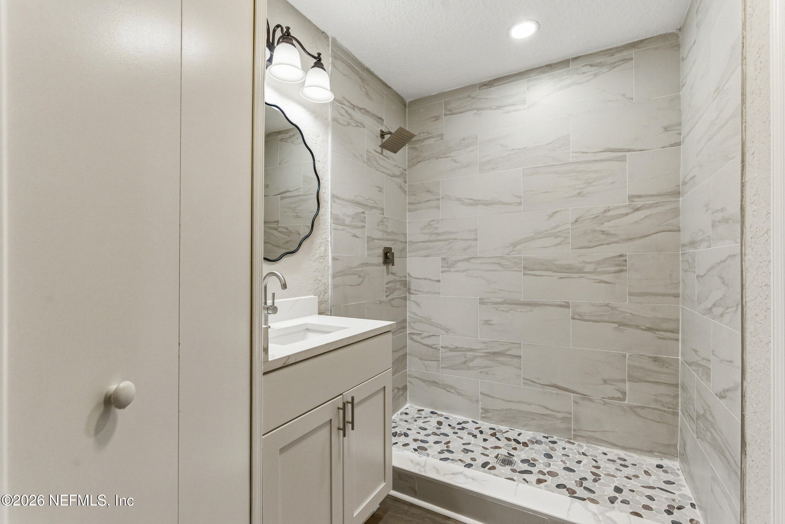 10531 Rutgers Road Jacksonville, FL 32218 - Photo 19 of 32 a bathroom with a sink a toilet and shower