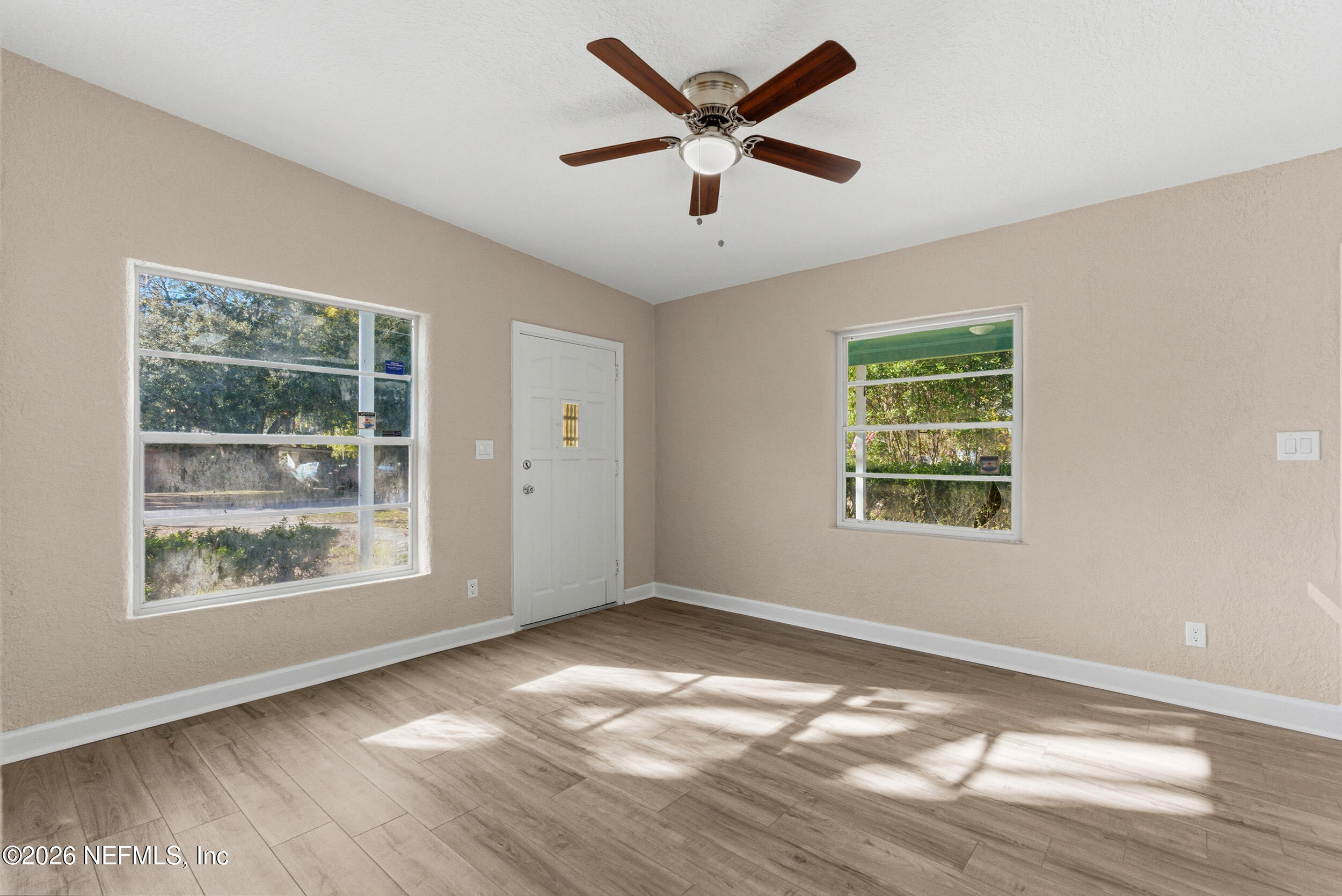 10531 Rutgers Road Jacksonville, FL 32218 - Photo 21 of 32 a view of an empty room with wooden floor and a window