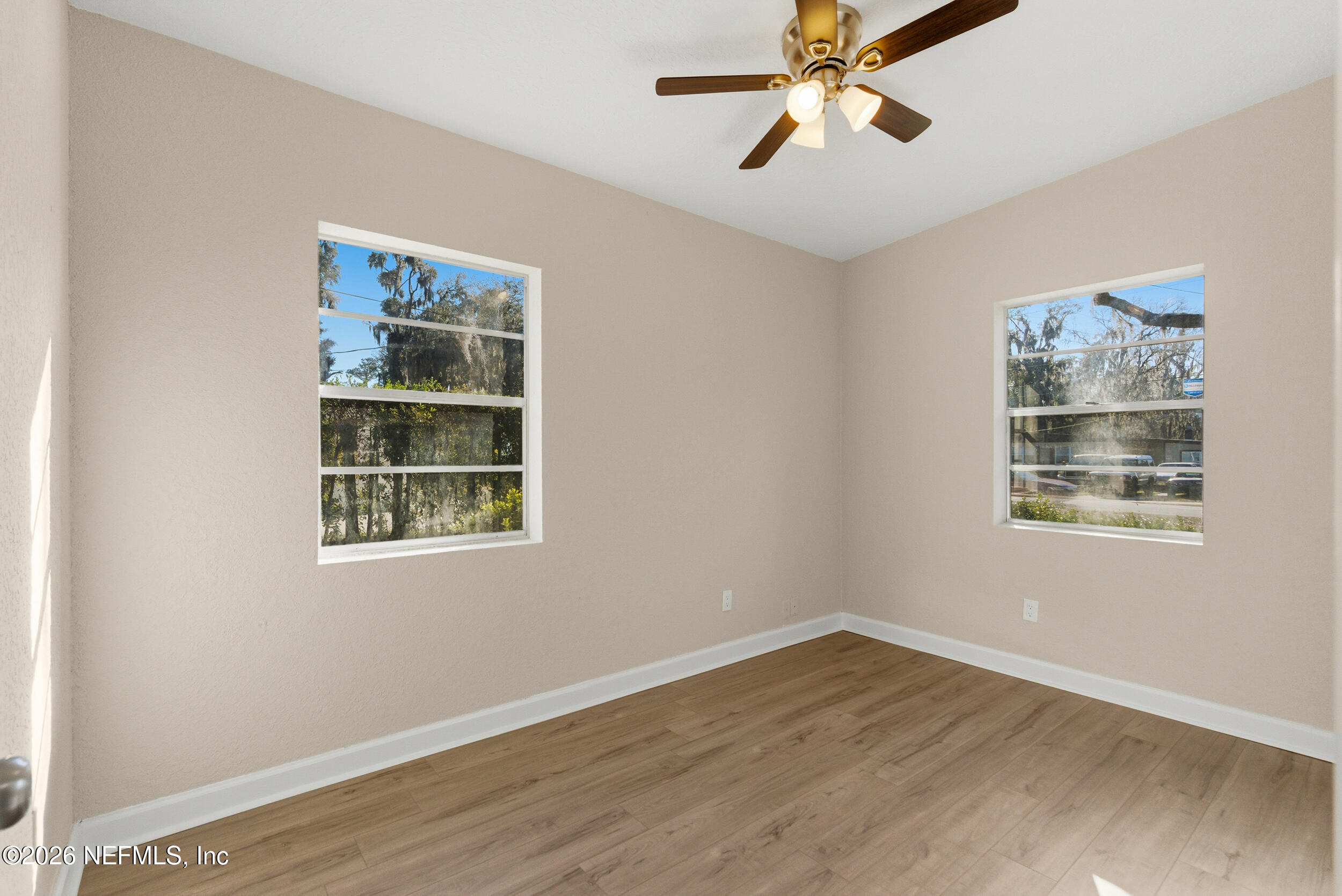 10531 Rutgers Road Jacksonville, FL 32218 - Photo 22 of 32 a view of an empty room with wooden floor and a window