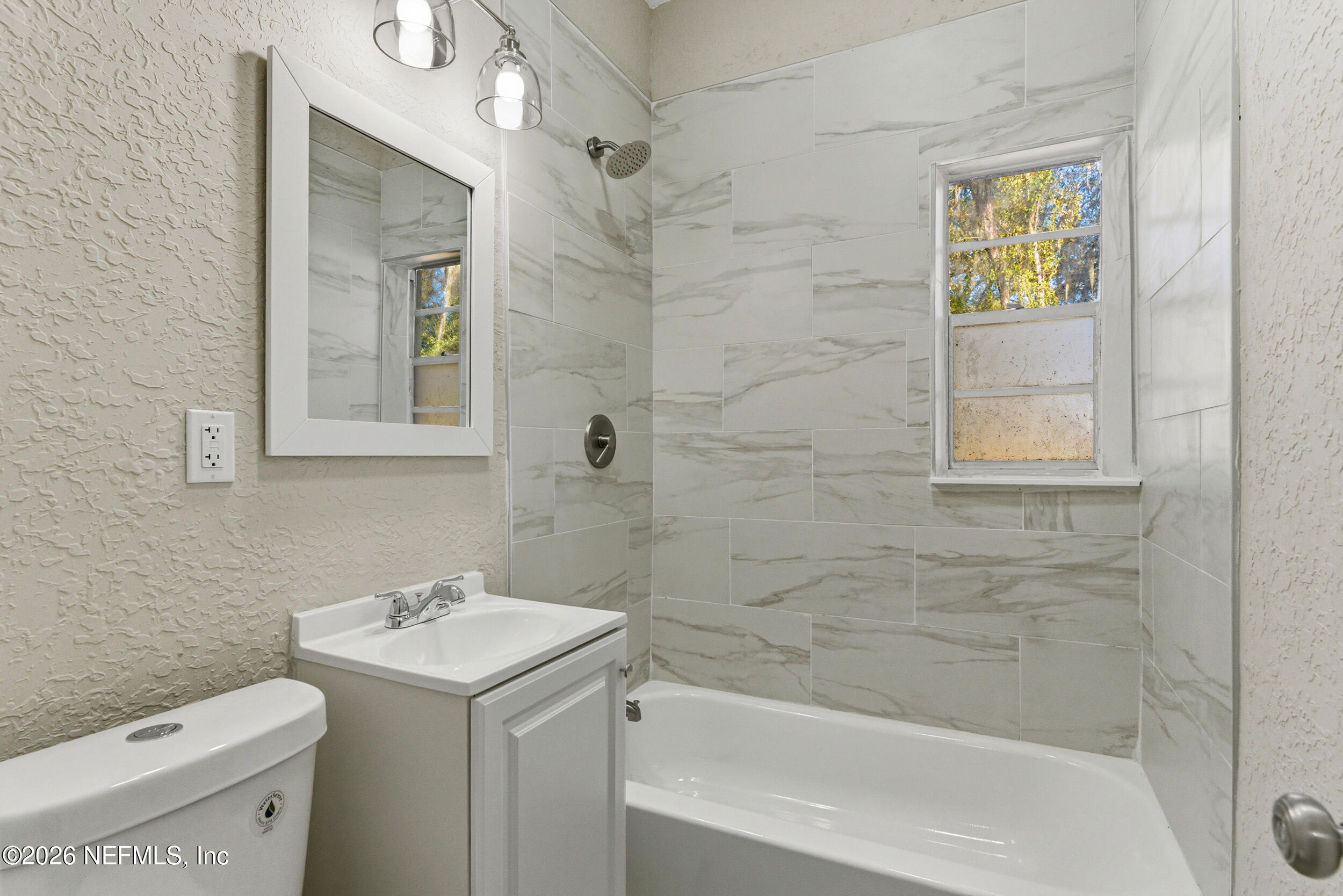 10531 Rutgers Road Jacksonville, FL 32218 - Photo 23 of 32 a bathroom with a sink a toilet and shower