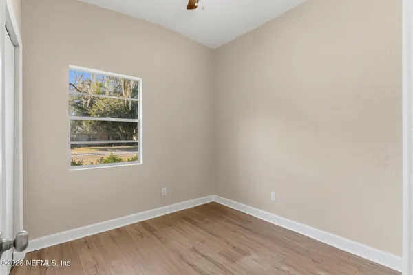 wooden floor in an empty room with a window