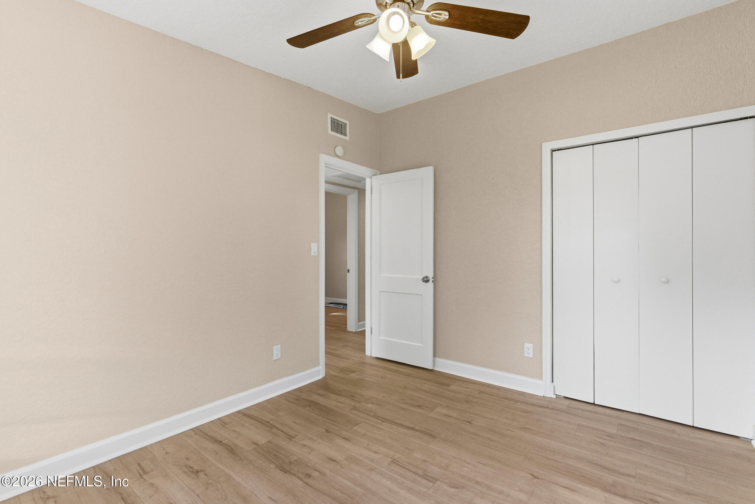 10531 Rutgers Road Jacksonville, FL 32218 - Photo 27 of 32 an empty room with wooden floor closet and windows