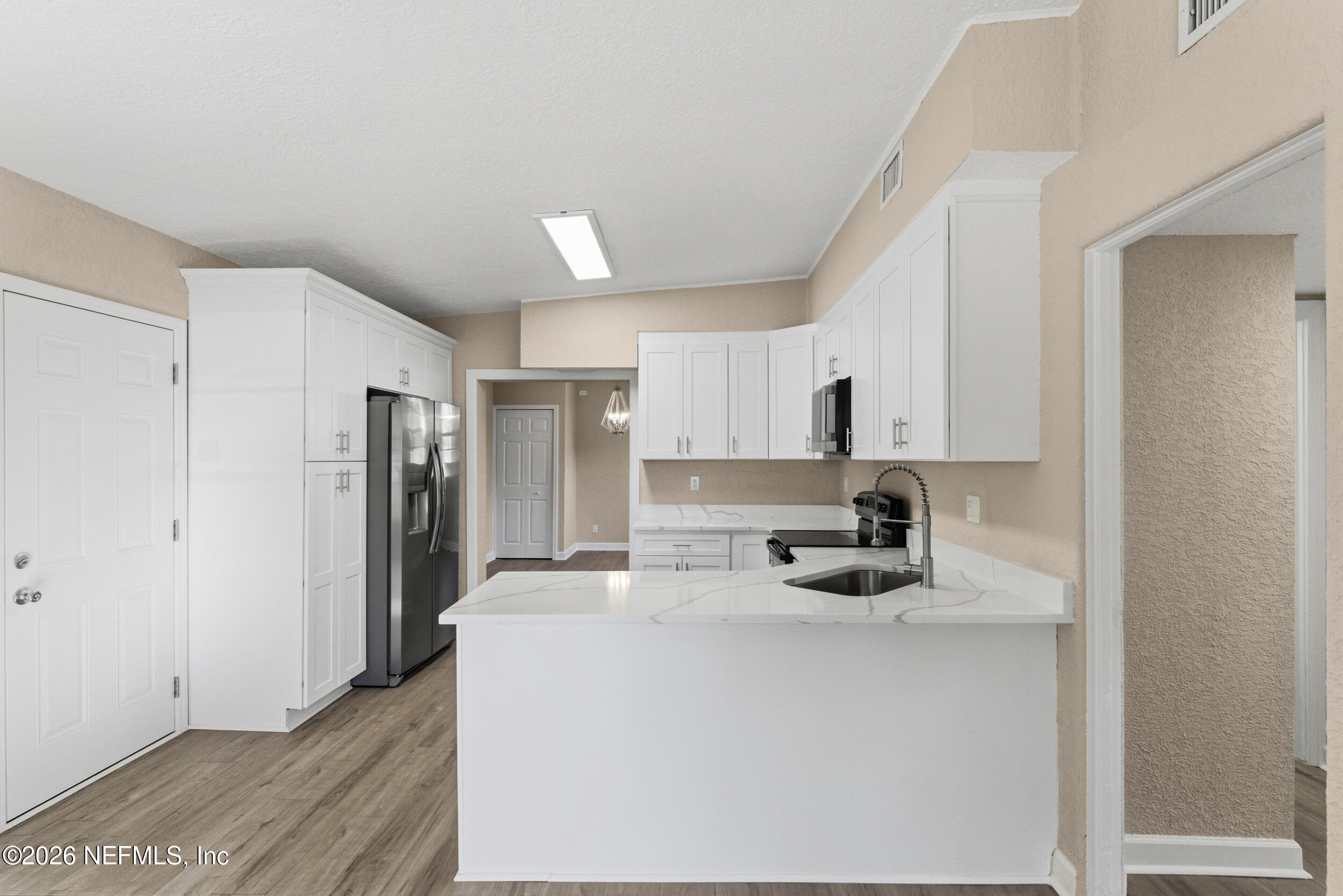 10531 Rutgers Road Jacksonville, FL 32218 - Photo 7 of 32 a kitchen with stainless steel appliances a refrigerator sink and white cabinets