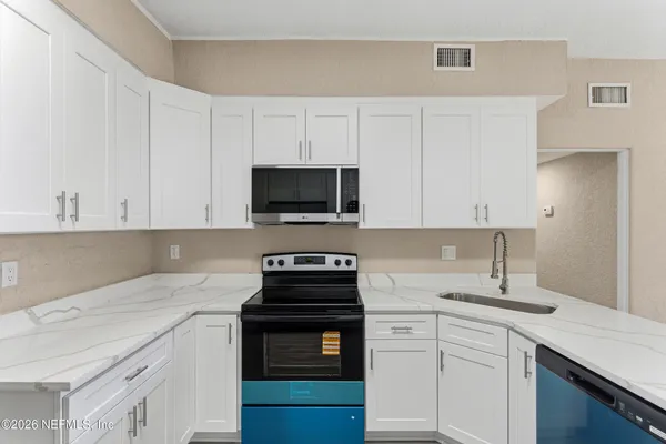 a kitchen with a sink and a stove top oven
