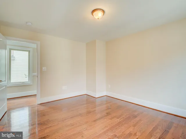 a view of a hallway with wooden floor and entryway