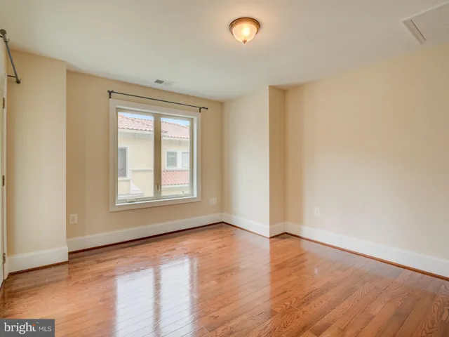 a kitchen with granite countertop a sink cabinets and stainless steel appliances