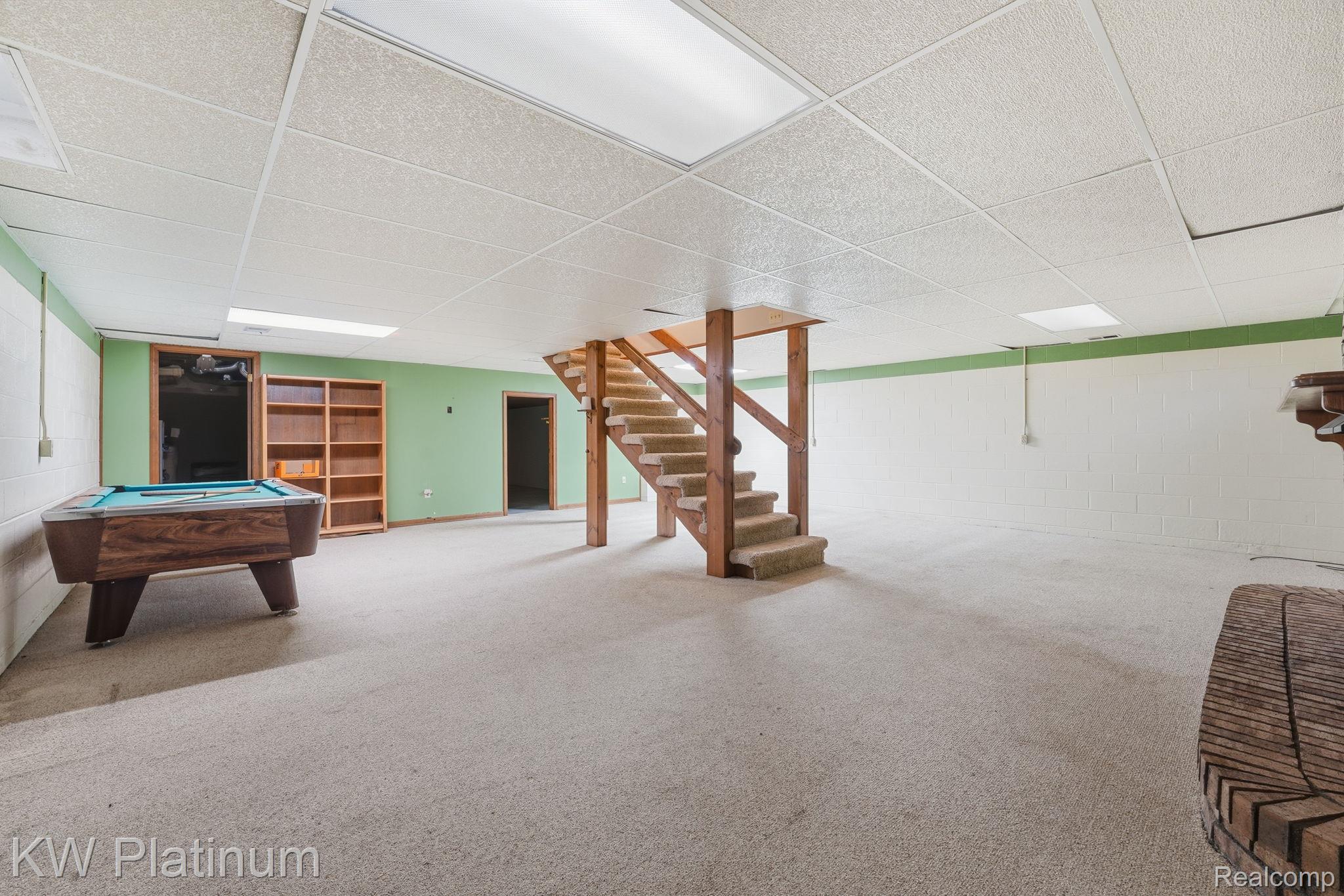 7383 Fisher Road Jeddo, MI 48032 - Photo 22 of 40 Rec room with a drop ceiling, concrete block wall, pool table, and carpet floors