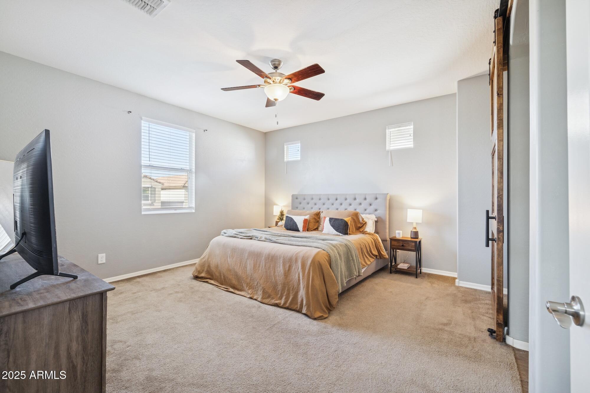 4124 East Toledo Street Gilbert, AZ 85295 - Photo 14 of 33 a bedroom with a bed and a flat screen tv