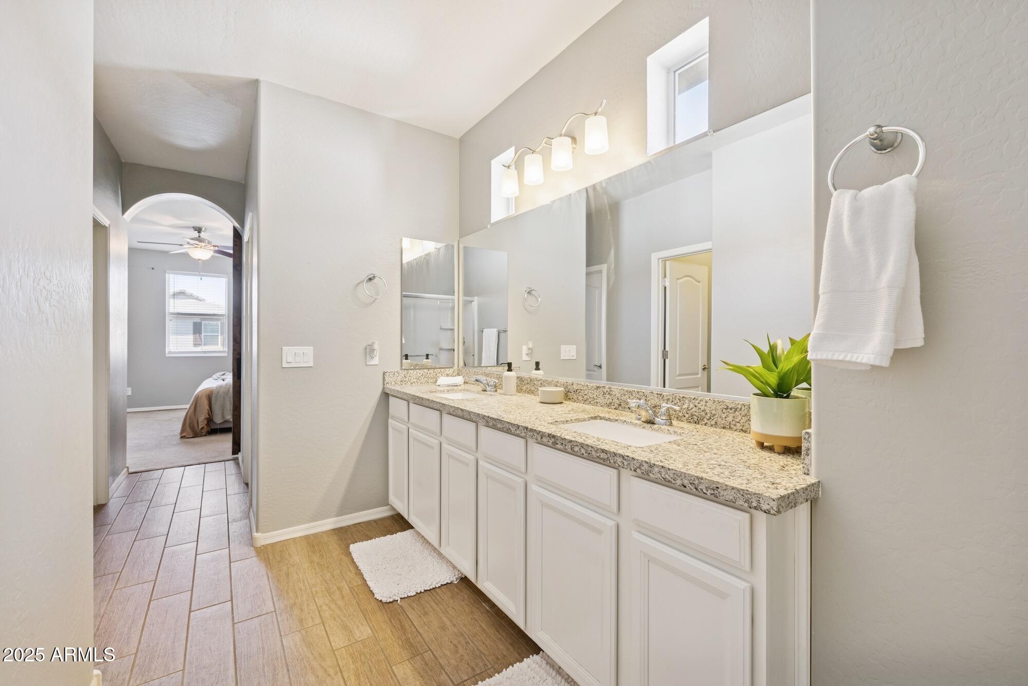 4124 East Toledo Street Gilbert, AZ 85295 - Photo 16 of 33 a spacious bathroom with a granite countertop sink and a mirror