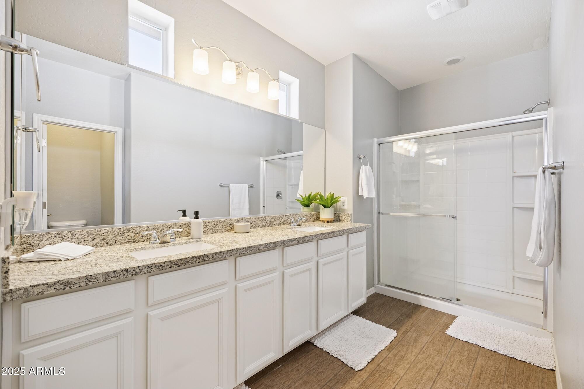 4124 East Toledo Street Gilbert, AZ 85295 - Photo 17 of 33 a bathroom with a granite countertop sink and a mirror