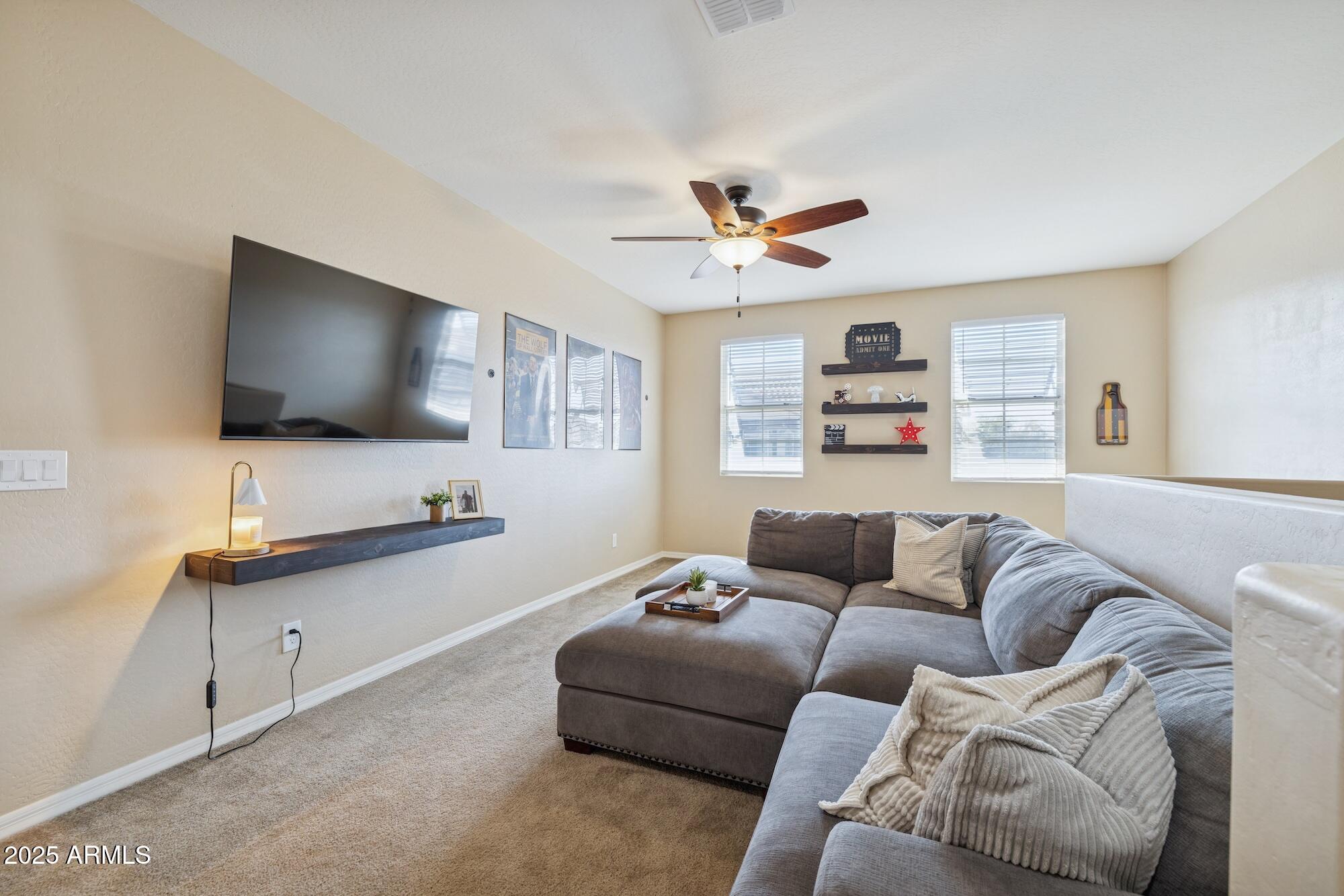 4124 East Toledo Street Gilbert, AZ 85295 - Photo 21 of 33 a living room with furniture and a flat screen tv