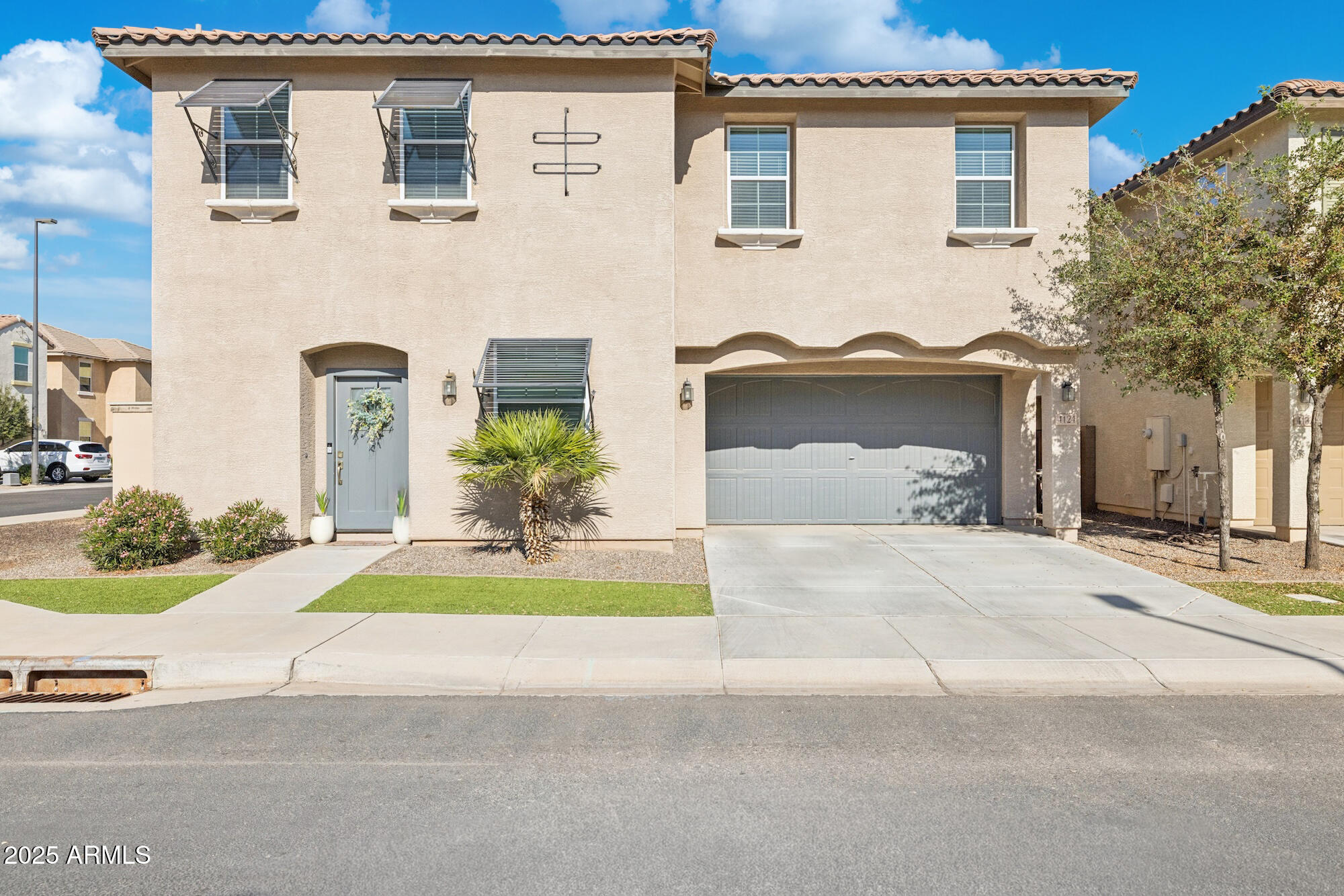 4124 East Toledo Street Gilbert, AZ 85295 - Photo 29 of 33 a front view of a house with a yard and potted plants