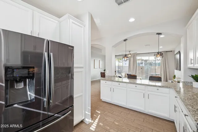 a kitchen with stainless steel appliances a sink and a refrigerator