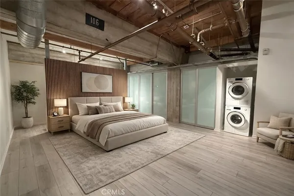 a spacious bedroom with a bed a couch and a table