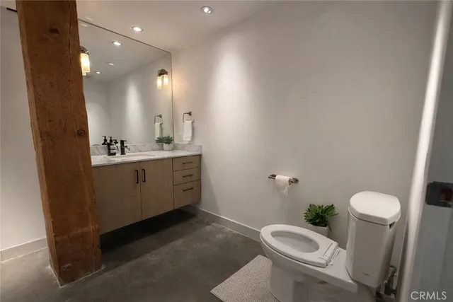 a bathroom with a sink toilet and mirror