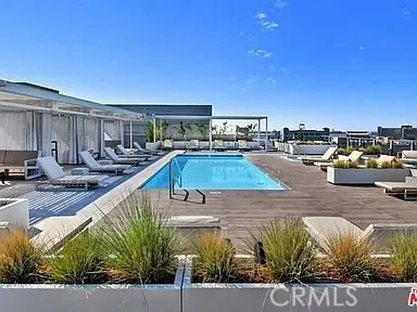 a view of a swimming pool with a lounge chair