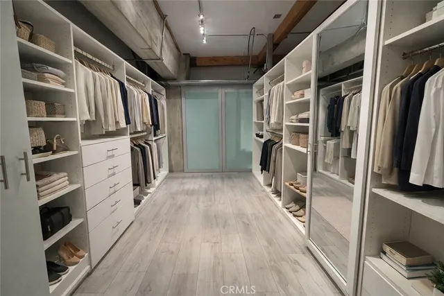 a view of walk in closet with empty racks