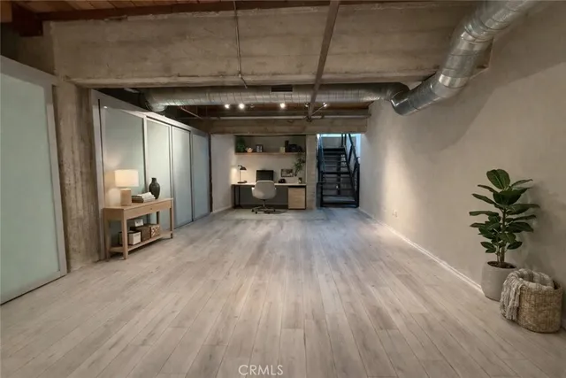 a view of a room with wooden floor and furniture