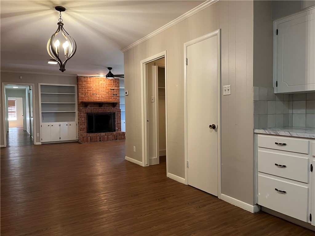 749 San Patricio Avenue Taft, TX 78390 - Photo 13 of 40 an empty room with wooden floor fireplace and staircase
