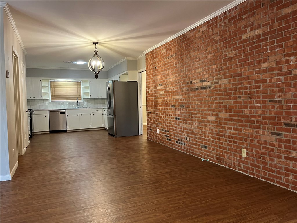 749 San Patricio Avenue Taft, TX 78390 - Photo 22 of 40 a view of a refrigerator in kitchen and wooden floor