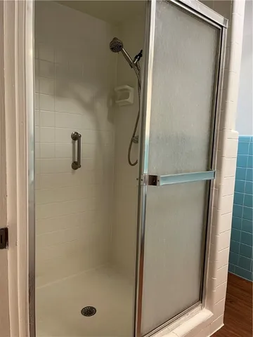 a bathroom with a glass shower door