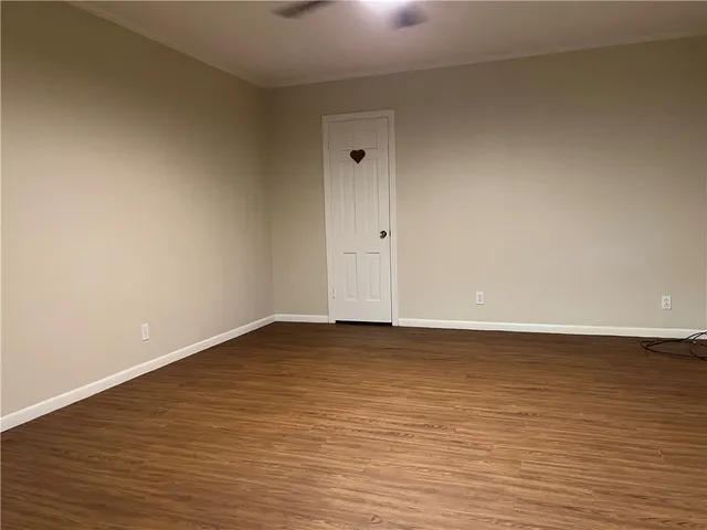 a view of an empty room and wooden floor
