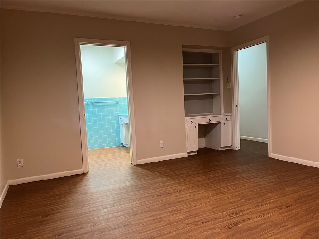 749 San Patricio Avenue Taft, TX 78390 - Photo 27 of 40 an empty room with wooden floor closet and windows