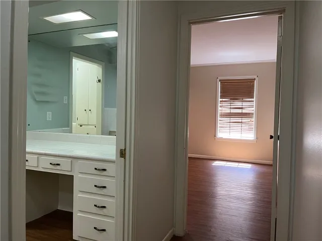 a bathroom with a granite countertop sink a mirror and a bathtub