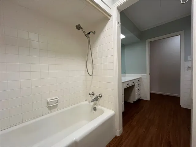 a bathroom with a bathtub a sink a toilet and a shower