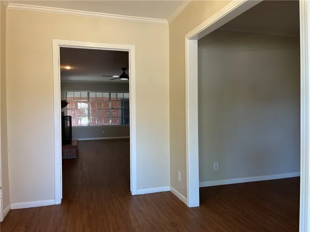 a view of a hallway with wooden floor