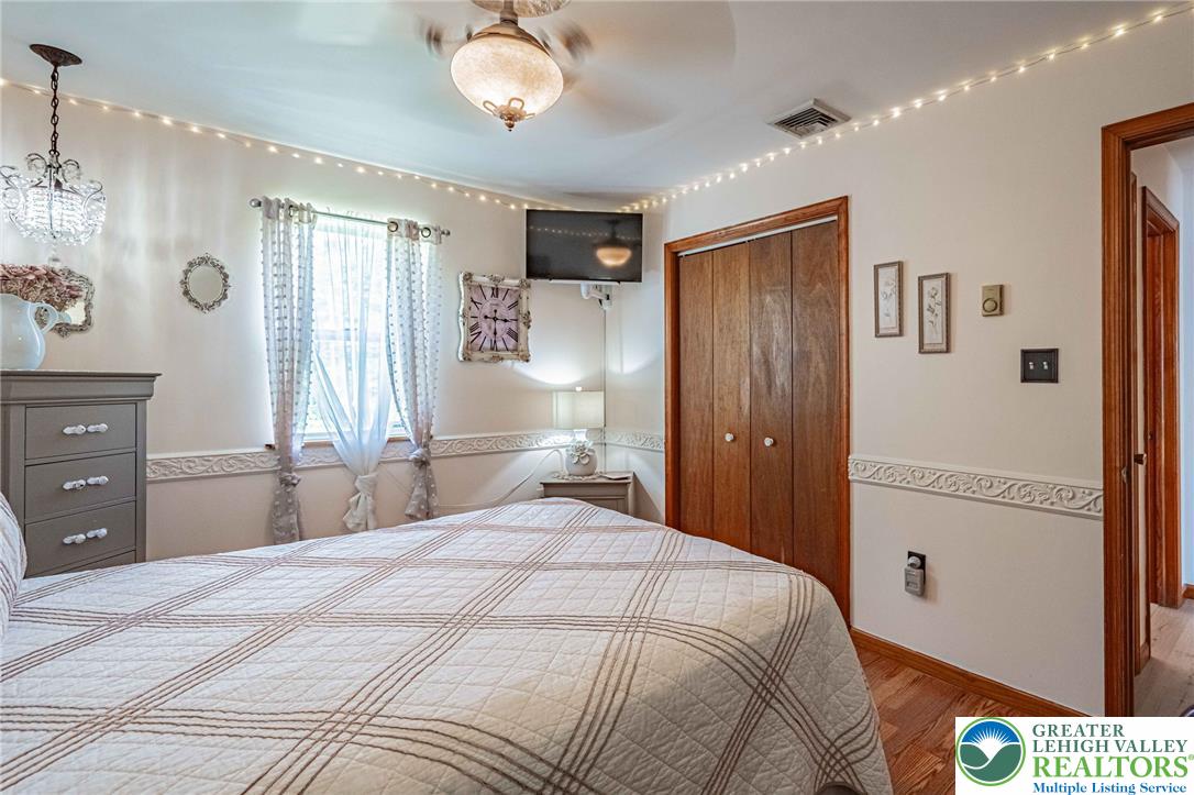 341 Lower Greenhill Road Kunkletown, PA 18058 - Photo 25 of 69 Wood floors and a bright window define this charming bedroom.