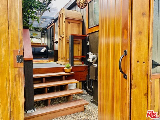 a view of staircase with a door and a chair