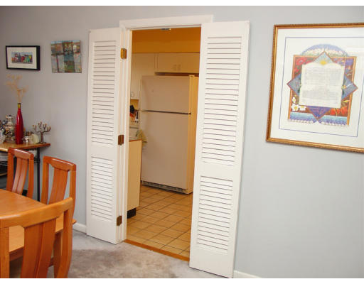 141 Lake Shore Road, Unit 3 Boston, MA 02135 - Photo 4 of 20 a view of hallway with wooden floor and a bookshelf